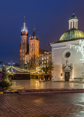 Fototapeta na wymiar Krakow, Poland, Main Square, Sw Wojciech church and St Mary's church in the winter season, during Christmas fairs