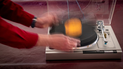 Motion blur of a record being dropped on a turntable