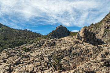 Panoramic view of Rocks - Los Roques in La Gomera island. A volcanic plug, also called a volcanic neck or lava neck, is a volcanic object created when magma hardens within a vent on an active volcano
