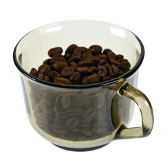 Dark roasted coffee beans in glass cup