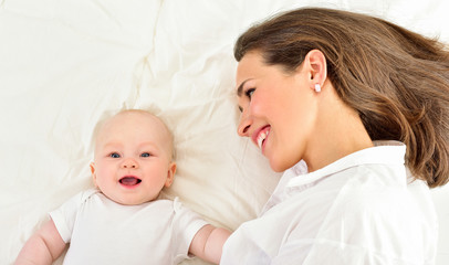 Mother and baby playing and smiling. Happy family.