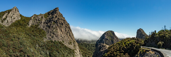 Panoramic view of The Rocks - Los Roques in La Gomera. A volcanic plug, also called a volcanic neck or lava neck, is a volcanic object created when magma hardens within a vent on an active volcano