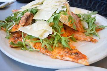 Slices of freshly cooked pizza with cheese on top