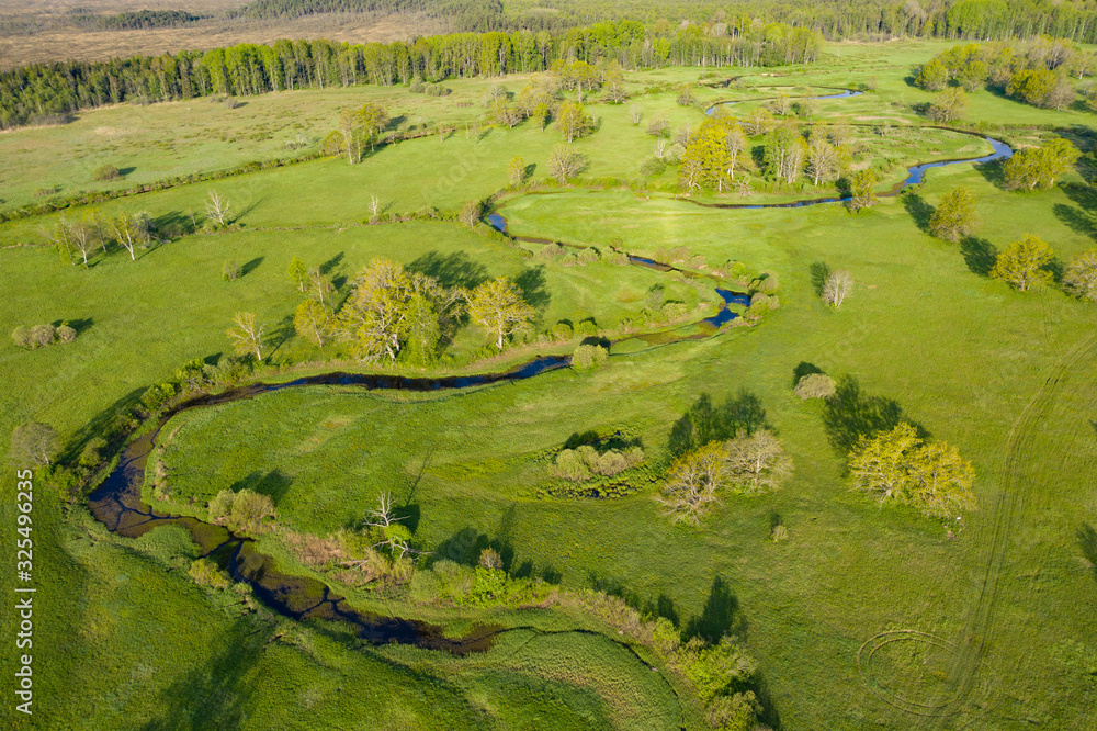 Sticker Forest in summer colors. Green deciduous trees and winding blue river in sunset. Tõramaa meadow, Estonia, Europe