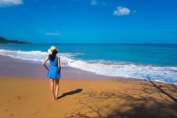 Fototapeta na wymiar Girl in blue dress at Caribbean beach, Guadeloupe