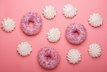 many marshmallows with donuts isolated on pink background