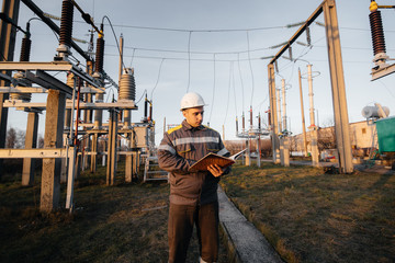 The energy engineer inspects the equipment of the substation. Power engineering. Industry