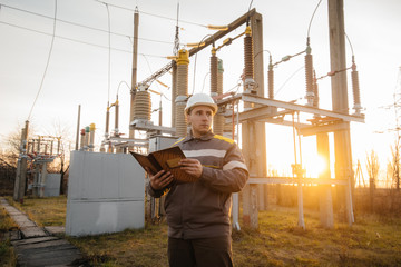 The energy engineer inspects the equipment of the substation. Power engineering. Industry