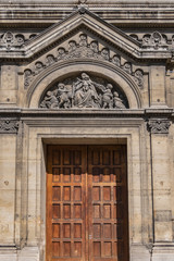 Fototapeta na wymiar Architectural fragments of Eglise Notre-Dame-des-Champs (Notre-Dame of the Fields, 1876) at boulevard du Montparnasse. Paris, France.