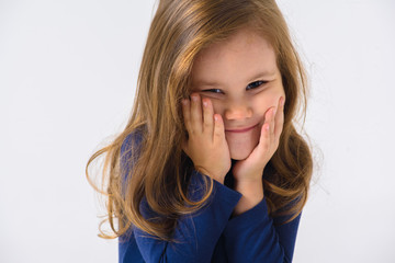 portrait of a little emotional girl who is surprised, smiling, on a white background