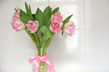 Pink Tulips in vase and ribbon light background