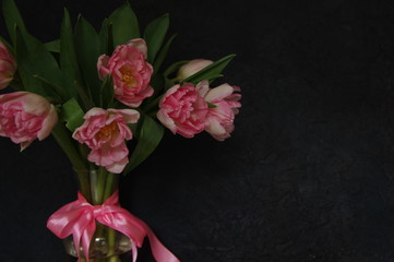 Pink Tulips in vase and ribbon dark background