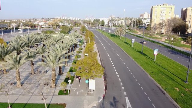 Camera on drone follows a group of runners on a bike path in Beer-Sheva
