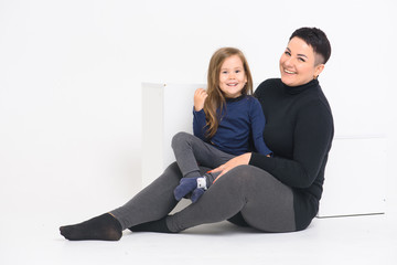 emotional portrait of mom and daughter, on a white background