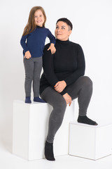 emotional portrait of mom and daughter, on a white background