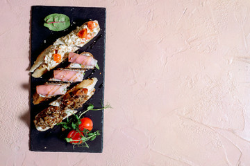 Meat, cheeses and fresh vegetables.snack set. Traditional tapas - spanish table with food or italian appetizer: bruschetta with cheese and meat.