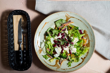 Mixed green salad with vegetables and nuts. vegan salad with beans. Natural nutrition. Fresh vegetables. Healthy eating concept.Restaurant menu