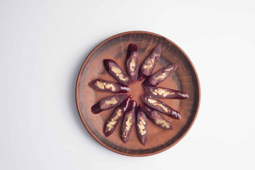churchkhela sprinkled with icing sugar on a plate with oriental-style ornament