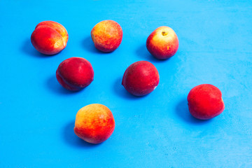Peaches close-up on a blue background. Summer fruits.