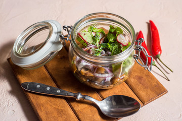 fresh vegetables in a glass jar in a restaurant. Cabbage and radish with sauce