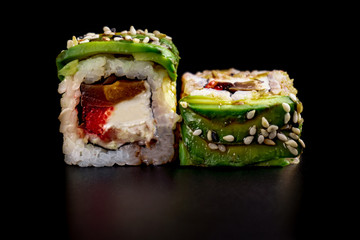 Close up composition of tuna maki sushi rolls japanese food style on a black background