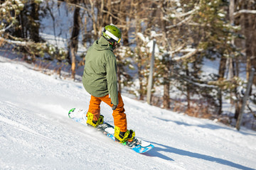 Snowboarder having fun riding hill at ski resort