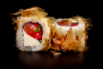 Close up composition of tuna maki sushi rolls japanese food style on a black background