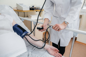 The doctor advises and serves a young pregnant girl in a medical clinic. Medical examination
