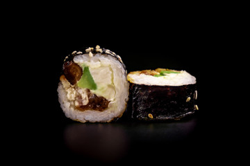 Close up composition of tuna maki sushi rolls japanese food style on a black background