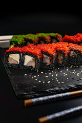 Set of sushi with wasabi and chopsticks on slate