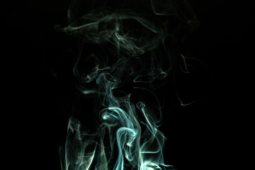 Smoke/incense rising against black background
