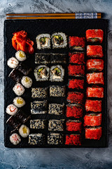 Set of sushi with wasabi and chopsticks on slate
