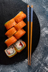 Set of sushi with wasabi and chopsticks on slate