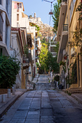 Narrow street scene in Athens with a view of filopappou hill
