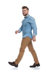 Fototapeta premium Side view of a confident casual man walking