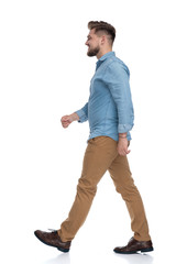 Fototapeta premium Side view of a happy casual man walking