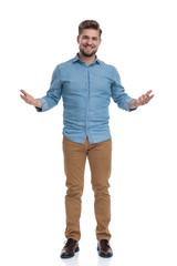 Cheerful casual man welcoming and smiling