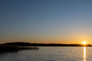 Bj&ouml;rn&ouml; landscape sunset silhouette with sun reflection