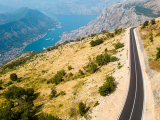 Obraz premium Aerial view of the Bay of Kotor, Boka. Scenic road overlooking the bay of the Kotor fjord. Winding roads to discover Montenegro. Tourism and cruise ships
