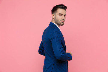 Rear view of a handsome businessman wearing blue suit