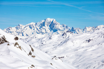 Fototapeta na wymiar Val Thorens, France - February 21, 2020: Winter Alps landscape from ski resort Val Thorens. Mont Blanc is the highest mountain in the Alps and the highest in Europe