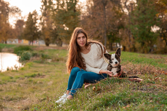 Young woman playing with her dog at the park