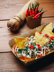 Mexican snack nachos with chili pepper on the wood