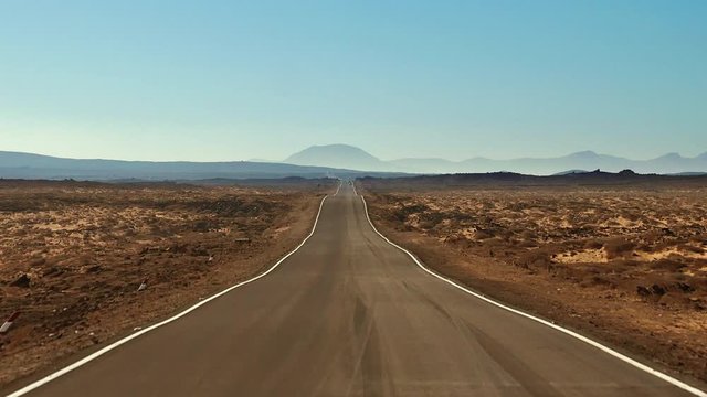 Driving POV in solitude on a breathtaking Arizona asphalt desert highway travel landscape road