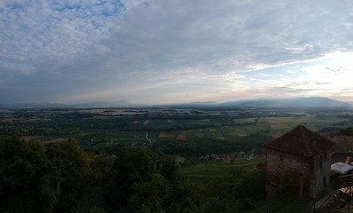 Drone panorama of a castle on a hill looking towards the wide plains and fields of Drava region in Vurberg, Maribor, Slovenia