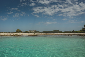 Tourquise coastal panorama of a croatian island, looking from the water towards the shore. Summer...