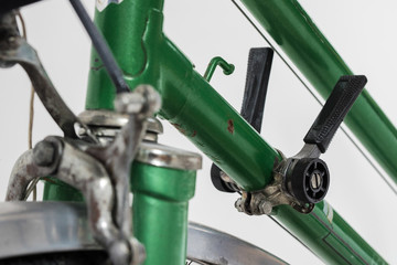 An old retro looking green vintage city bicycle for women, isolated o white background. Detail of...