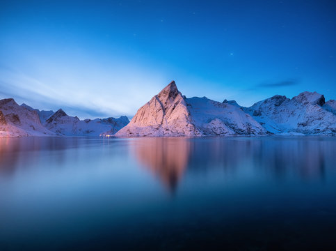 View on the mountains in the Hamnoy village, Lofoten Islands, Norway. Landscape in winter time during blue hour. Mountains and water. Travel - image