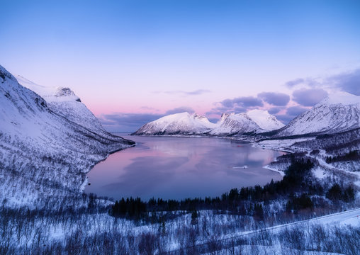 View on the mountains and ocean in the Senja island, Norway. Landscape in winter time during blue hour. Mountains and water. Travel - image