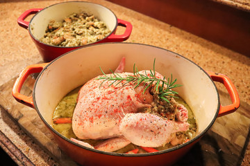 Top view of a raw chicken with stuffing in a pot
